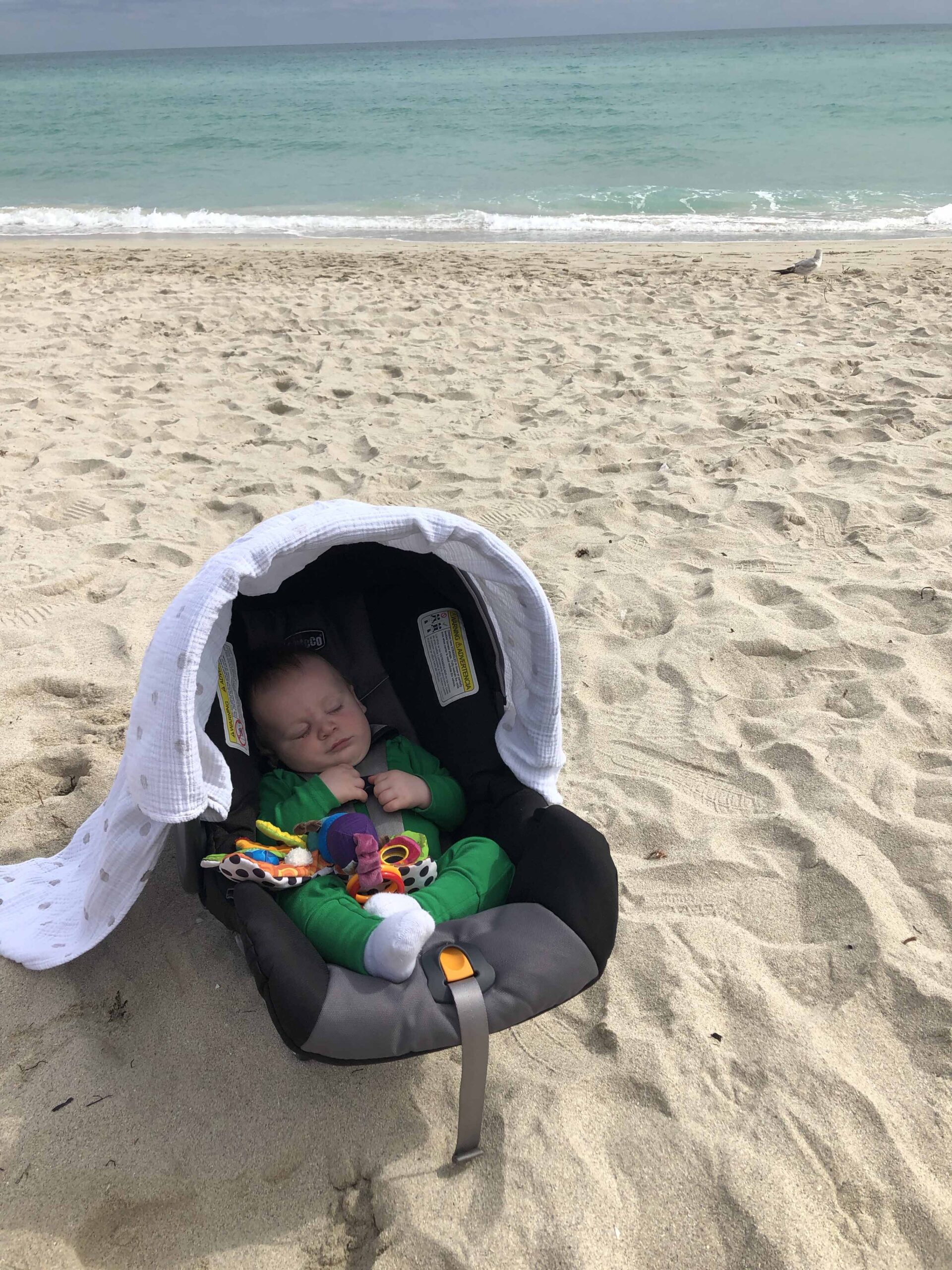 Baby sleeping on a beach