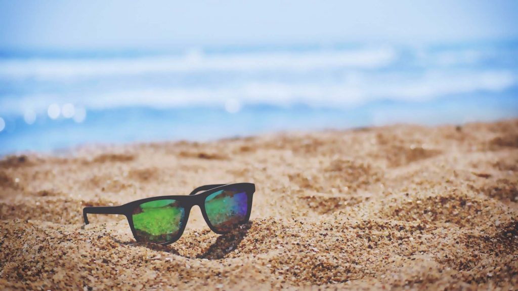 Reflective sunglasses on a beach