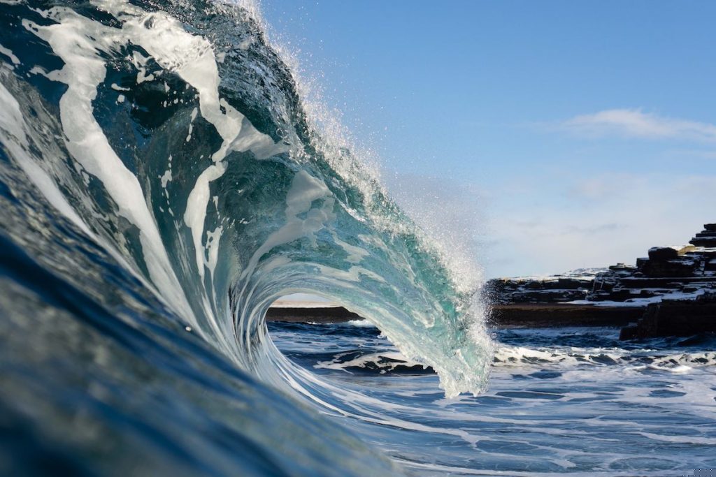 An ocean wave breaks