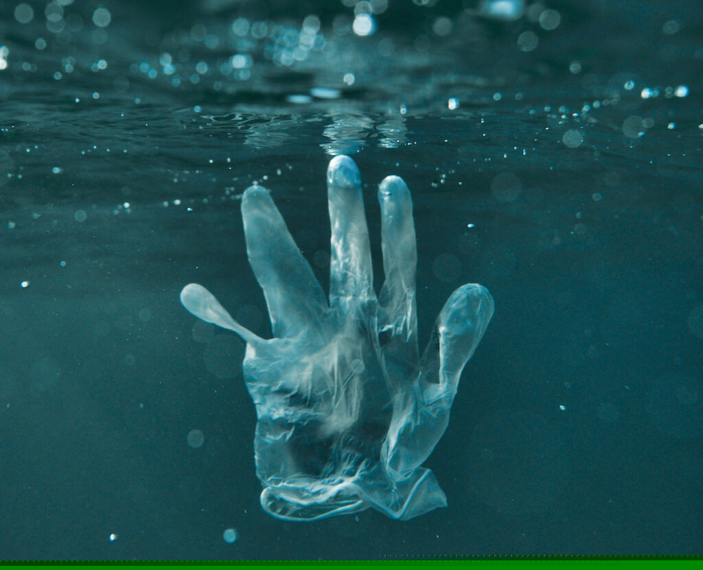 Single-use plastics in the ocean (a glove)